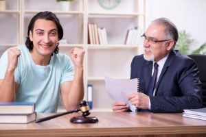 The young man visiting experienced male lawyer